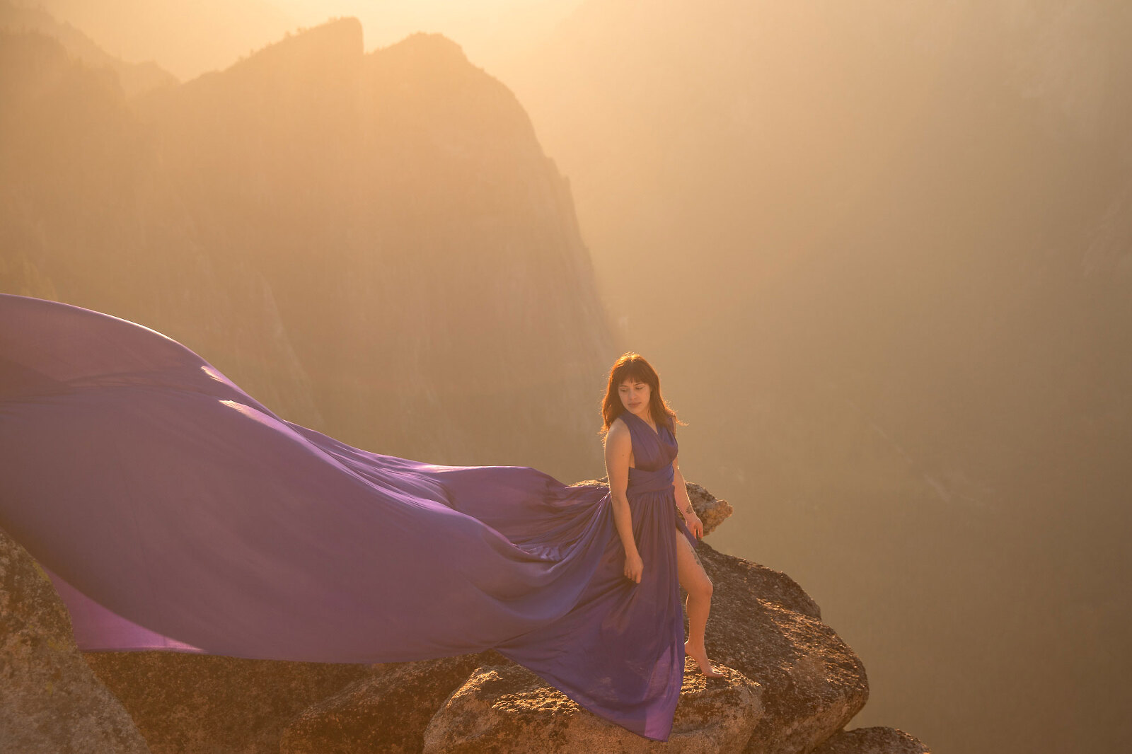 Woman stand on viewpoint with mountain and sunset.